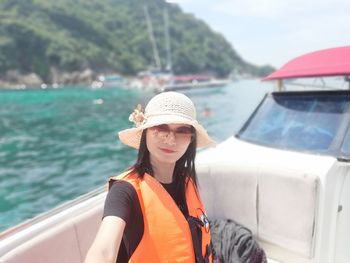 Portrait of young woman in boat on sea