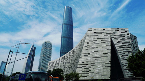 Low angle view of modern building against blue sky