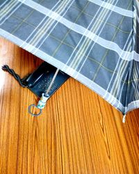 High angle view of umbrella on wooden table