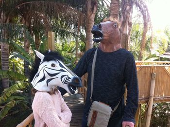 Man sitting on tree trunk in forest