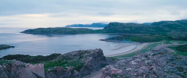 Panoramic view of sea and mountains against sky