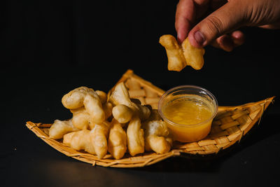 Cropped hand of person preparing food