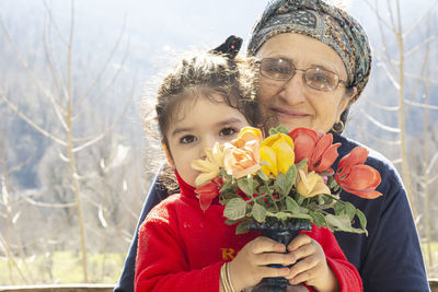 Portrait of woman with red flowers