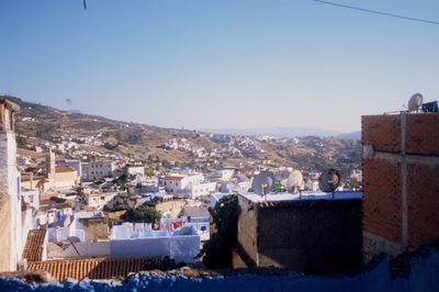 Townscape against clear blue sky