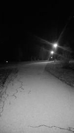 View of illuminated road at night