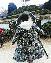 Rear view of woman standing in park