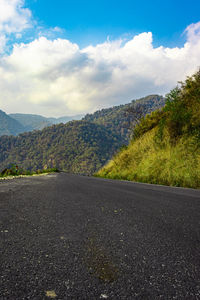 Asphalt tarmac isolated road with grass and blue sky at morning