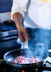 Midsection of man preparing food