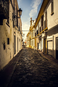 Empty alley amidst buildings in city