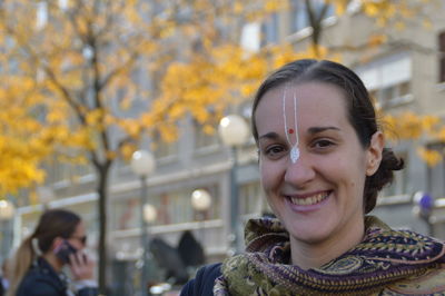 Portrait of a smiling young woman in city