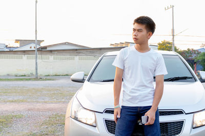 Full length of man standing in car