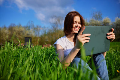 Portrait of young woman using mobile phone