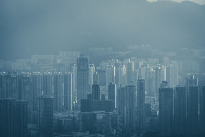 Aerial view of buildings in city against sky