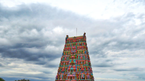 Low angle view of tower against cloudy sky