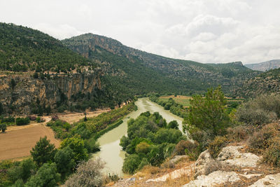 Scenic view of mountains against cloudy sky