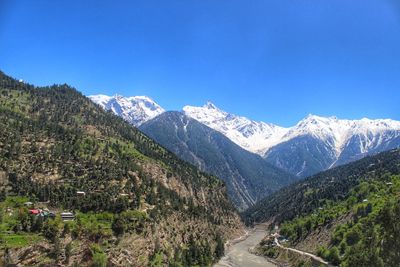 Scenic view of mountains against clear blue sky