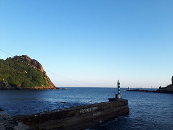 Scenic view of sea against clear blue sky