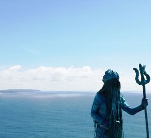 Rear view of women on sea against sky