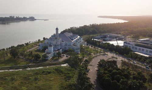 High angle view of buildings by sea against sky