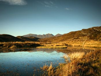 Scenic view of lake and mountains against sky