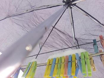 Low angle view of clothespins hanging on clothesline