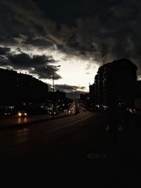 Cars on road against sky during sunset