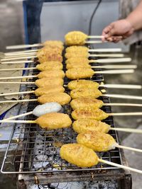 Person preparing food on barbecue grill