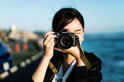 Portrait of woman photographing