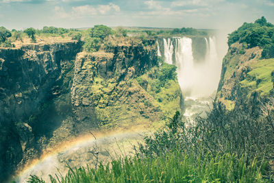 Scenic view of waterfall against sky