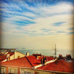 Houses against cloudy sky