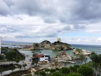 Townscape by sea against sky in city