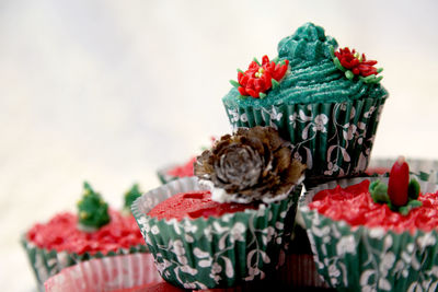 Close-up of christmas cupcakes against white background