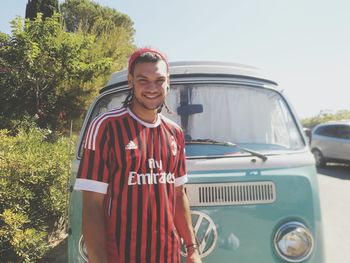 Portrait of smiling young man standing outdoors