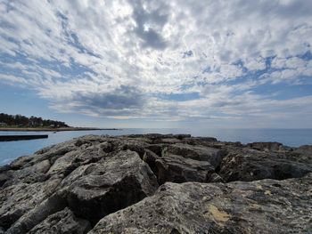 Rocks on beach against sky