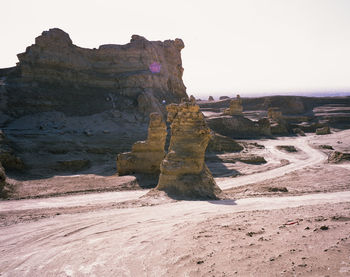 Rock formations on landscape against clear sky