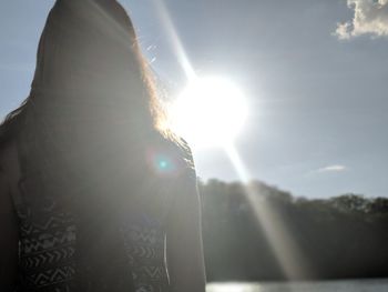 Portrait of woman against bright sun