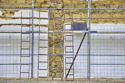 Abandoned building seen through fence