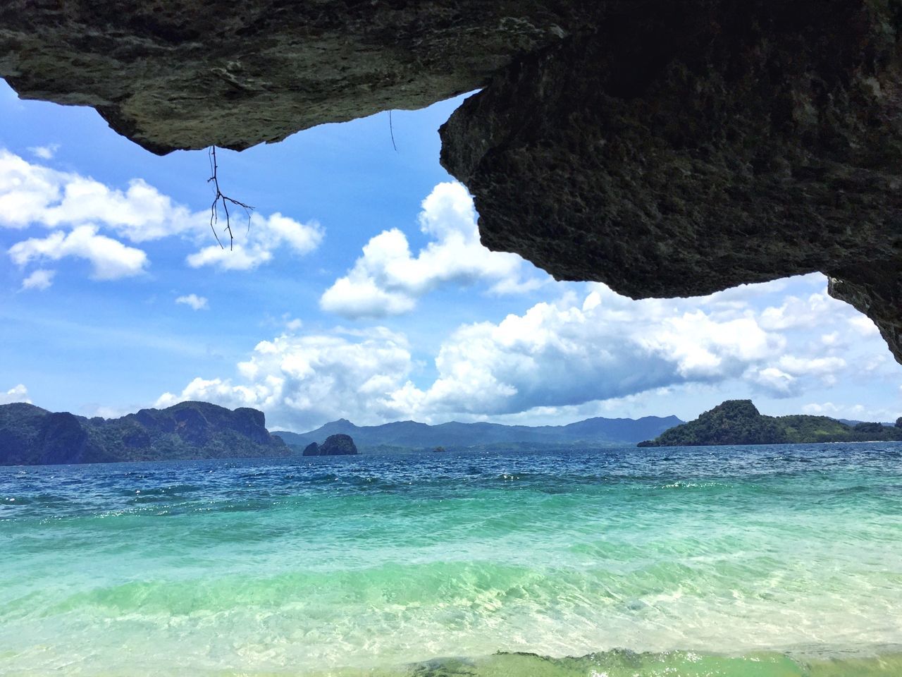 water, mountain, sea, sky, scenics, beauty in nature, tranquil scene, tranquility, nature, cloud - sky, waterfront, mountain range, cloud, idyllic, rock formation, rock - object, cloudy, day, coastline, beach