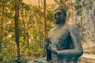 Statue against trees and plants