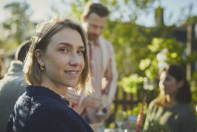 Smiling woman at table in garden