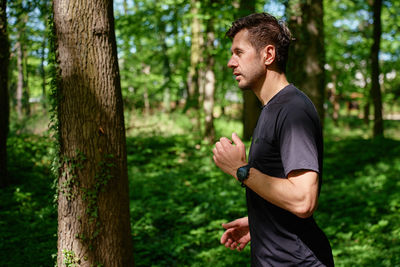 Young man exercising in forest