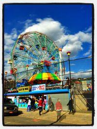 Ferris wheel against cloudy sky