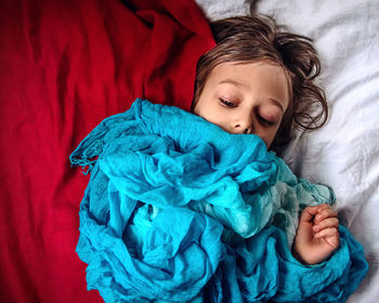 High angle view of kid lying on bed