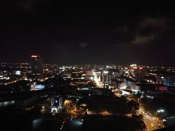 Aerial view of city lit up at night