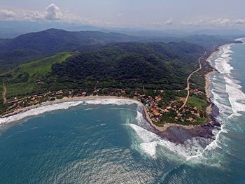 High angle view of land and sea against sky