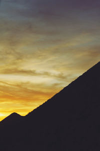 Scenic view of silhouette mountains against sky during sunset