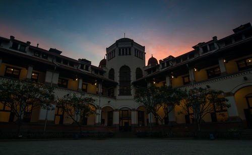 Low angle view of buildings against sky at sunset