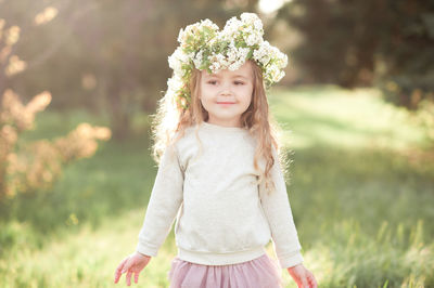 Portrait of girl wearing wreath at park