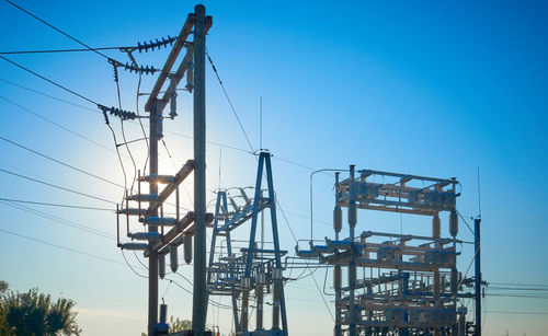 Low angle view of crane against clear blue sky