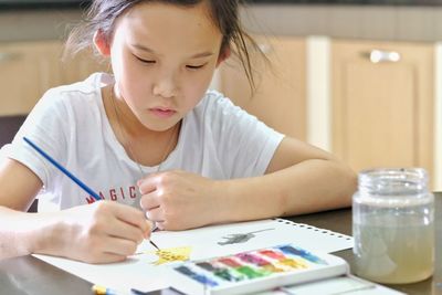 Midsection of girl holding table